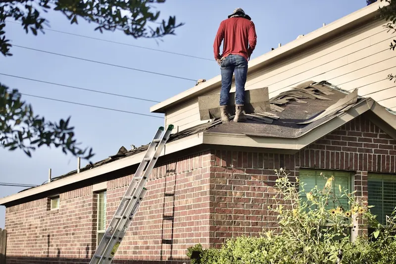 Professional roofer working on a residential roof in Mount Airy